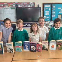Two children measuring a post in the school playground